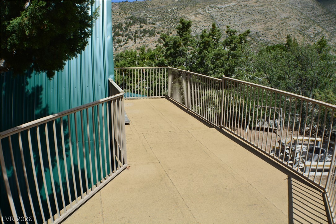 1321 Trout Canyon Road Las Vegas, NV 89124 - Photo 36 of 50 Enjoy the rugged landscape from a private outdoor patio, perfect for hillside contemplation.