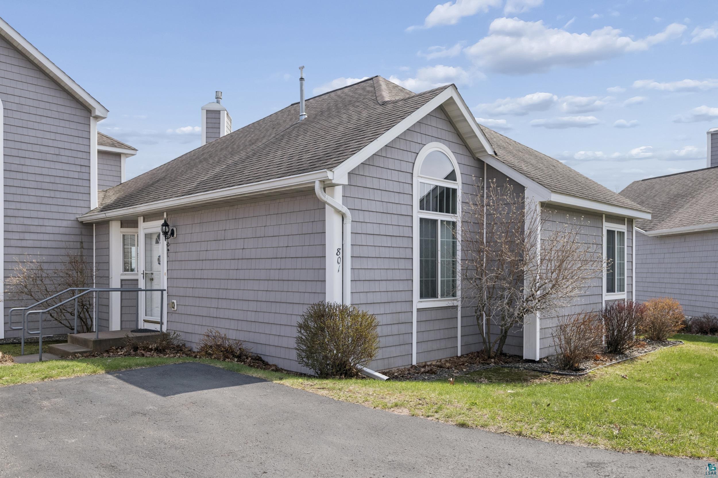 34590 Bay View Road, Unit 801 Bayfield, WI 54814 - Photo 4 of 36 Shingle-sided exterior featuring a prominent arched window and a gable roofline