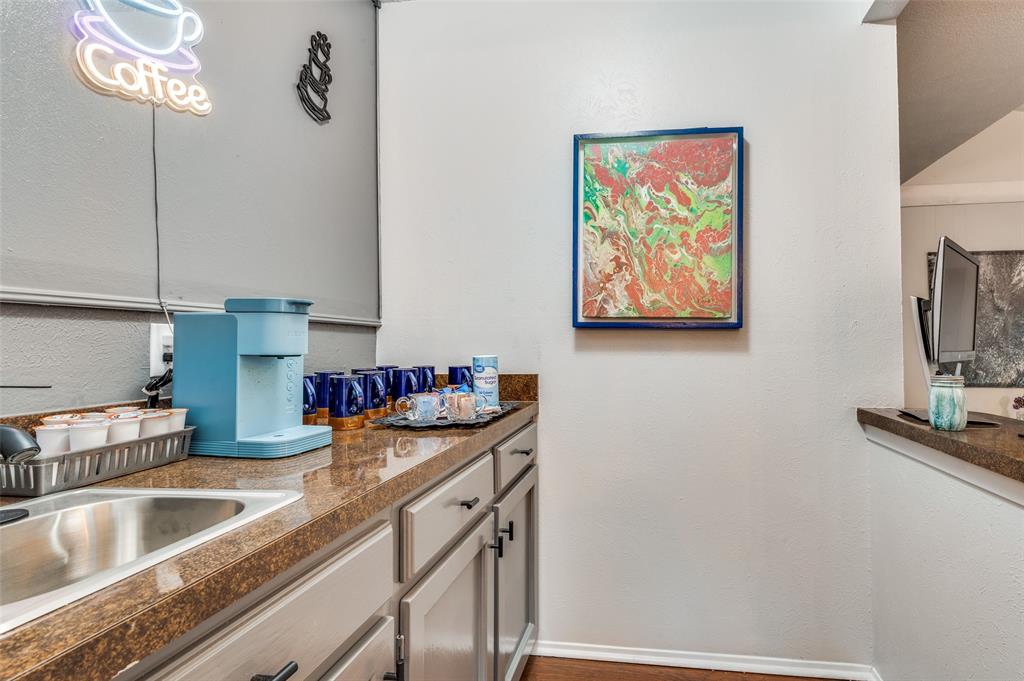37 Merrie Circle Richardson, TX 75081 - Photo 14 of 28 Kitchen with a textured wall and dark countertops