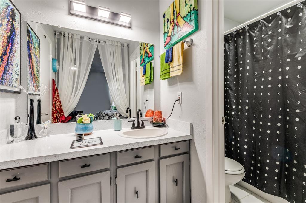 37 Merrie Circle Richardson, TX 75081 - Photo 19 of 28 Ensuite bathroom featuring vanity, light tile patterned floors, a shower with shower curtain, and a textured wall