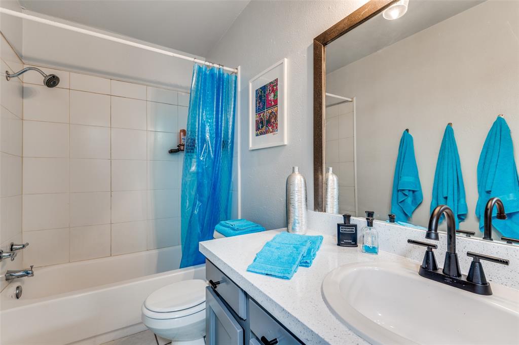 37 Merrie Circle Richardson, TX 75081 - Photo 21 of 28 Full bath with shower / bath combo, a textured wall, and vanity