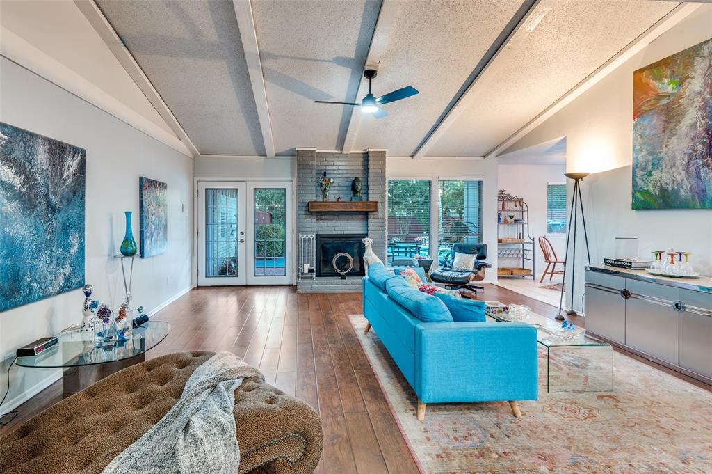 37 Merrie Circle Richardson, TX 75081 - Photo 6 of 28 Living room featuring a textured ceiling, hardwood / wood-style flooring, a fireplace, and a ceiling fan