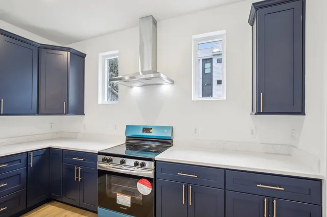 a kitchen with stainless steel appliances granite countertop a sink and cabinets