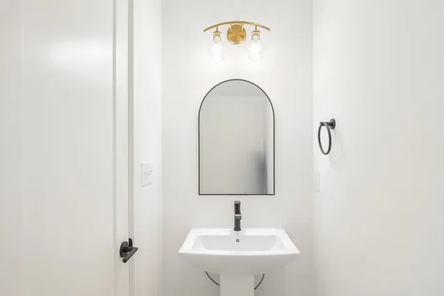 a bathroom with a sink and mirror