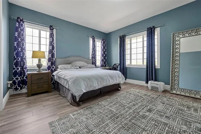 a bed sitting in a bedroom next to a window