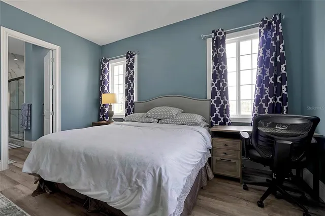 a bedroom with a bed and a television