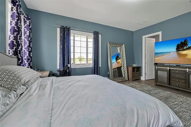 a bathroom with a granite countertop sink a toilet and a mirror