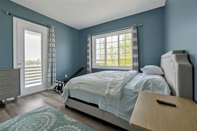a bed sitting in a bedroom next to a window
