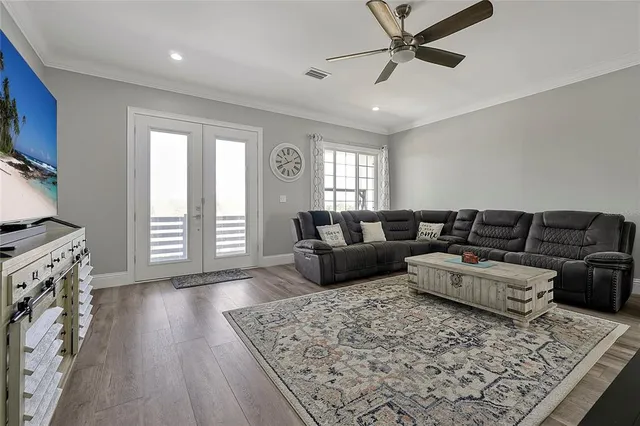 a living room with furniture and wooden floor