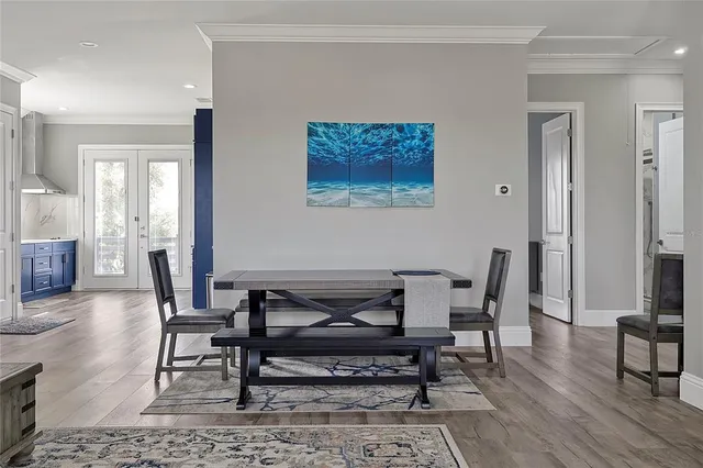 a large kitchen with wooden floors and wooden cabinets