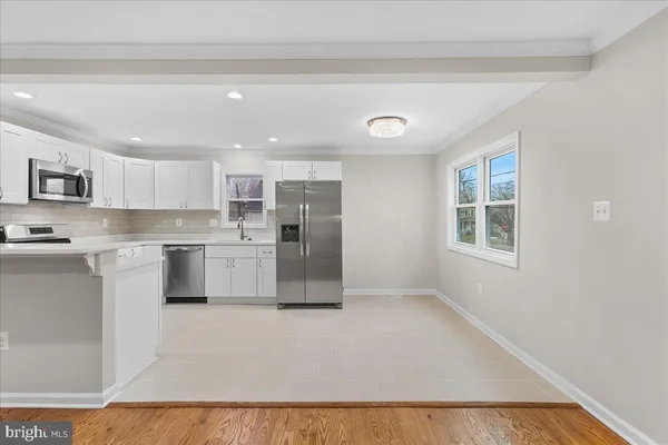 a kitchen with stainless steel appliances a refrigerator sink and cabinets