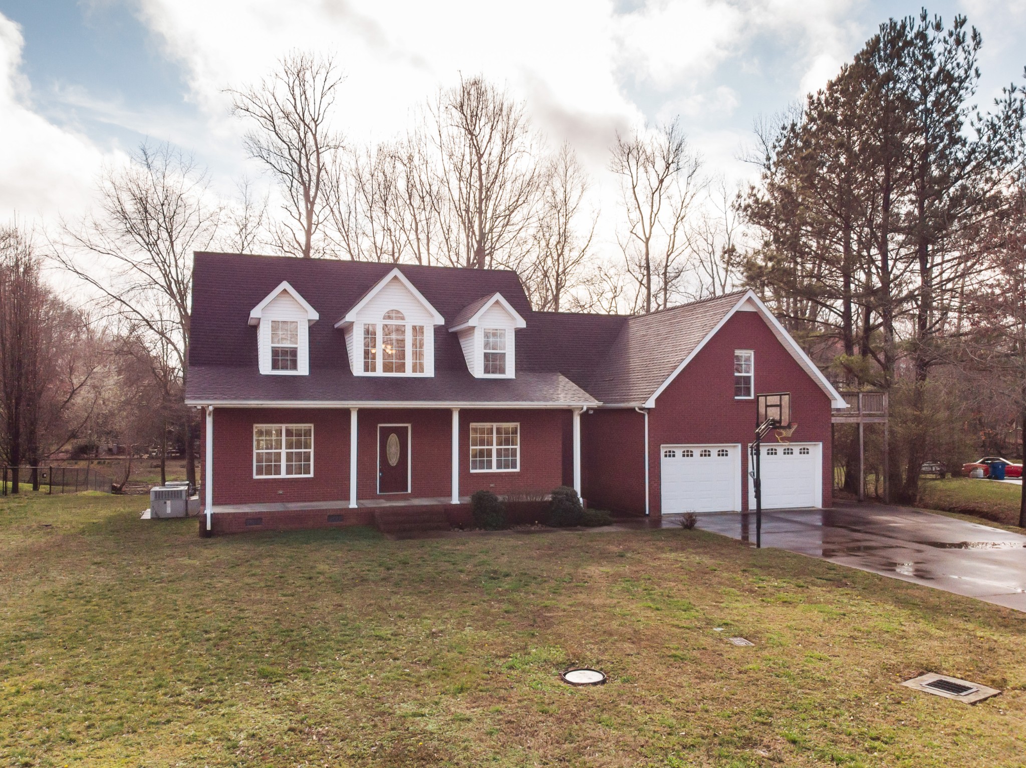 415 Duck River Road Manchester, TN 37355 - Photo 1 of 34 a front view of a house with a yard and large trees