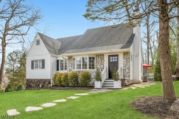 an aerial view of a house with a yard and lake view