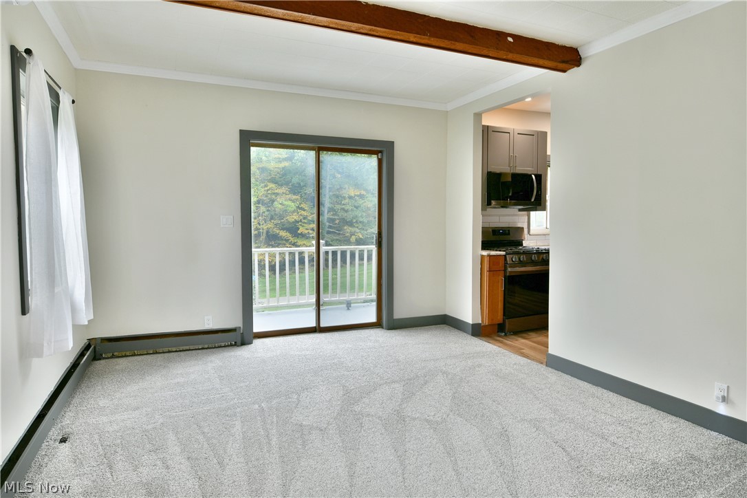 892 Yankee Run Road Masury, OH 44438 - Photo 10 of 50 Spacious room with light gray carpeting, exposed wood ceiling beam, and crown molding
