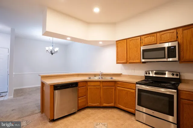 a kitchen with a sink and steel appliances