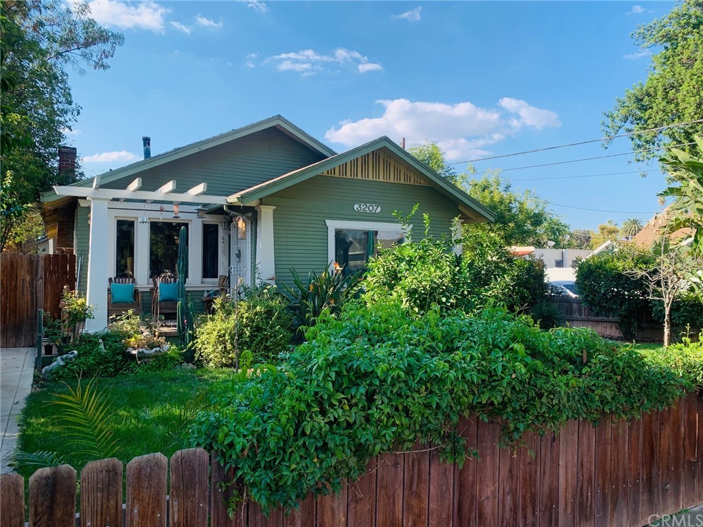 a front view of house with a garden