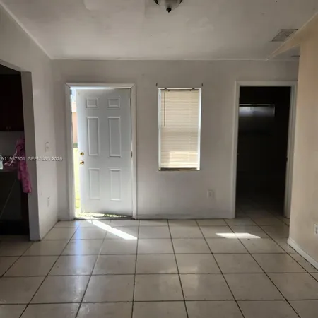 a kitchen with granite countertop a stove a sink and a refrigerator