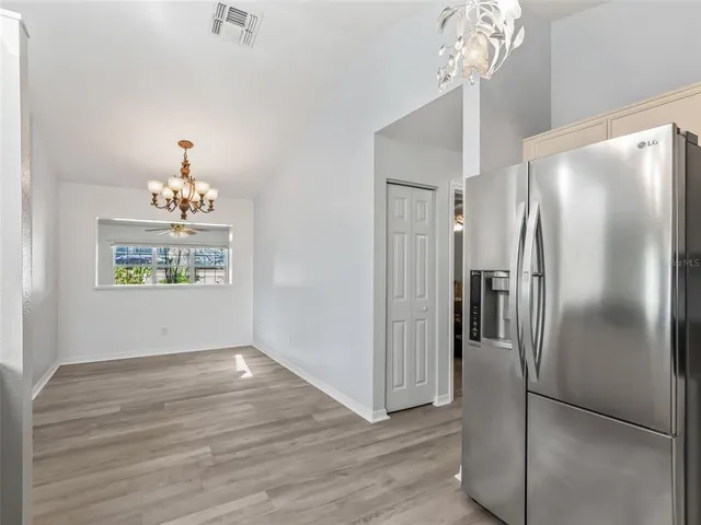 a view of a refrigerator in kitchen and wooden floor