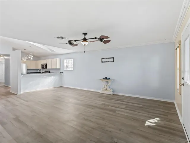 a view of a kitchen with a sink and a refrigerator