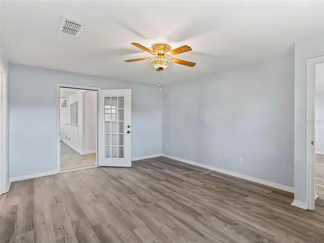 wooden floor in an empty room with a window