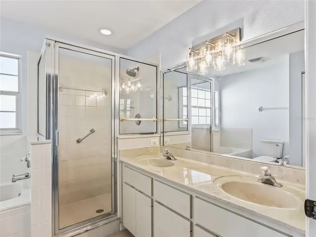 a bathroom with a shower sink and mirror