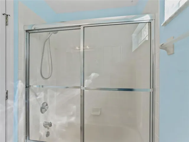 a bathroom with a glass shower door