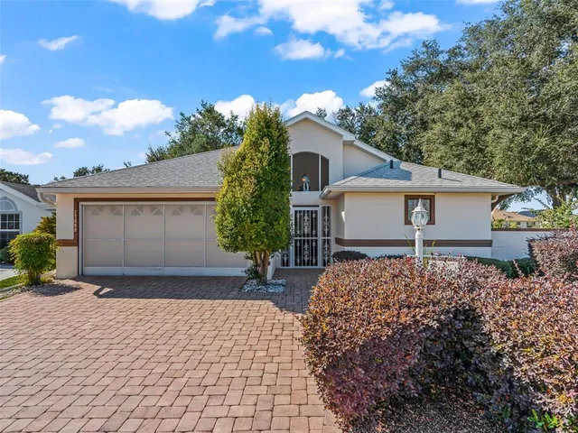 a front view of a house with a yard and a garage
