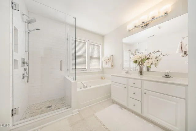 a spacious bathroom with a shower sink and mirror