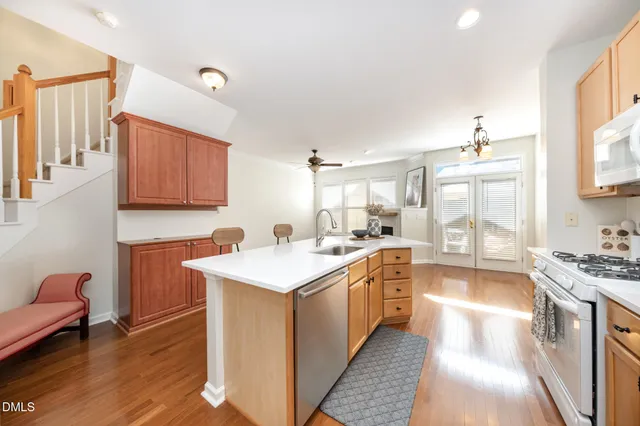 a kitchen with a sink stove and wooden cabinets