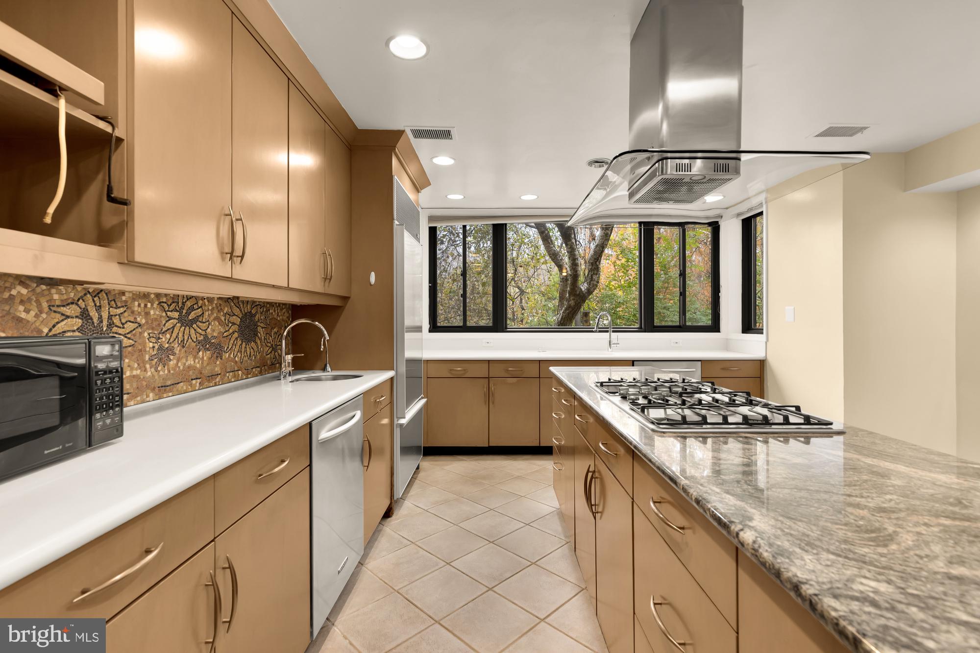 1434 Kirby Road McLean, VA 22101 - Photo 23 of 53 a kitchen with stainless steel appliances granite countertop a sink stove and cabinets
