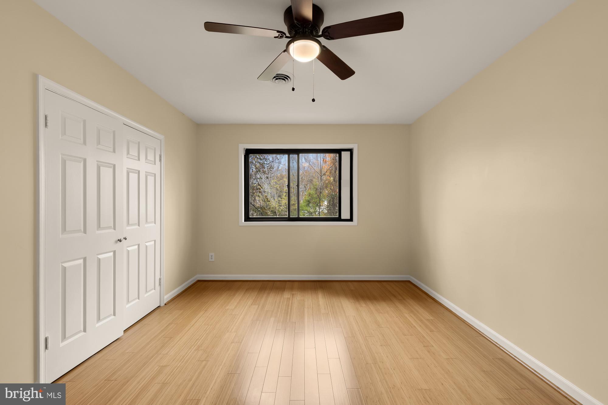 1434 Kirby Road McLean, VA 22101 - Photo 38 of 53 an empty room with wooden floor chandelier fan and windows