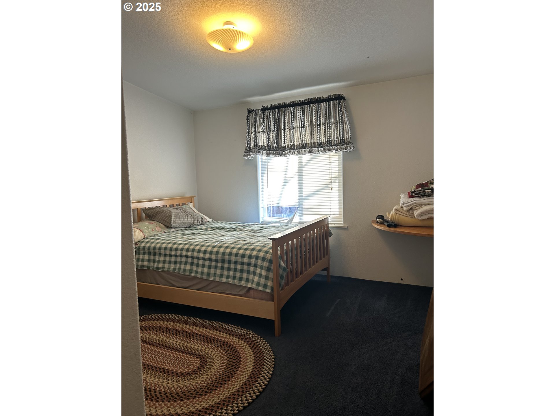 1105 Riverside Drive, Unit 17 Vernonia, OR 97064 - Photo 14 of 26 a bedroom with a bed and a window