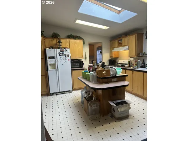 a kitchen with a sink a stove and cabinets