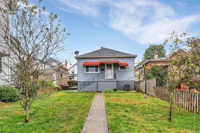 a front view of a house with a yard