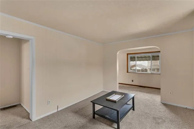 an empty room with furniture and window