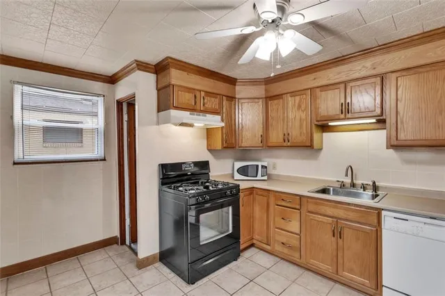 a kitchen with stainless steel appliances a stove a sink and cabinets
