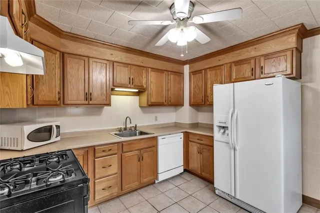 a kitchen with a stove a sink and a refrigerator