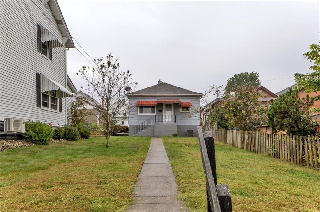 323 Sycamore Street Vandergrift, PA 15690 - Photo 20 of 28 a front view of a house with garden