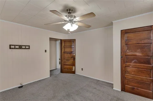 an empty room with closet and windows