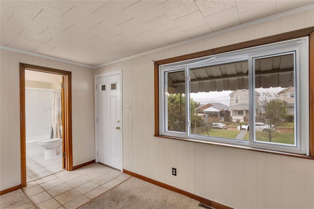 323 Sycamore Street Vandergrift, PA 15690 - Photo 4 of 28 an empty room with wooden floor and a window