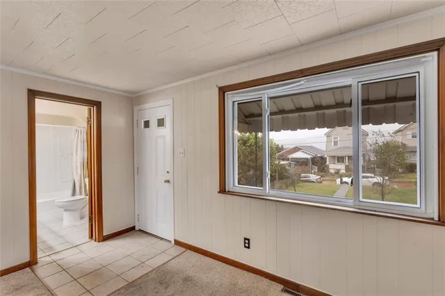 an empty room with wooden floor and a window