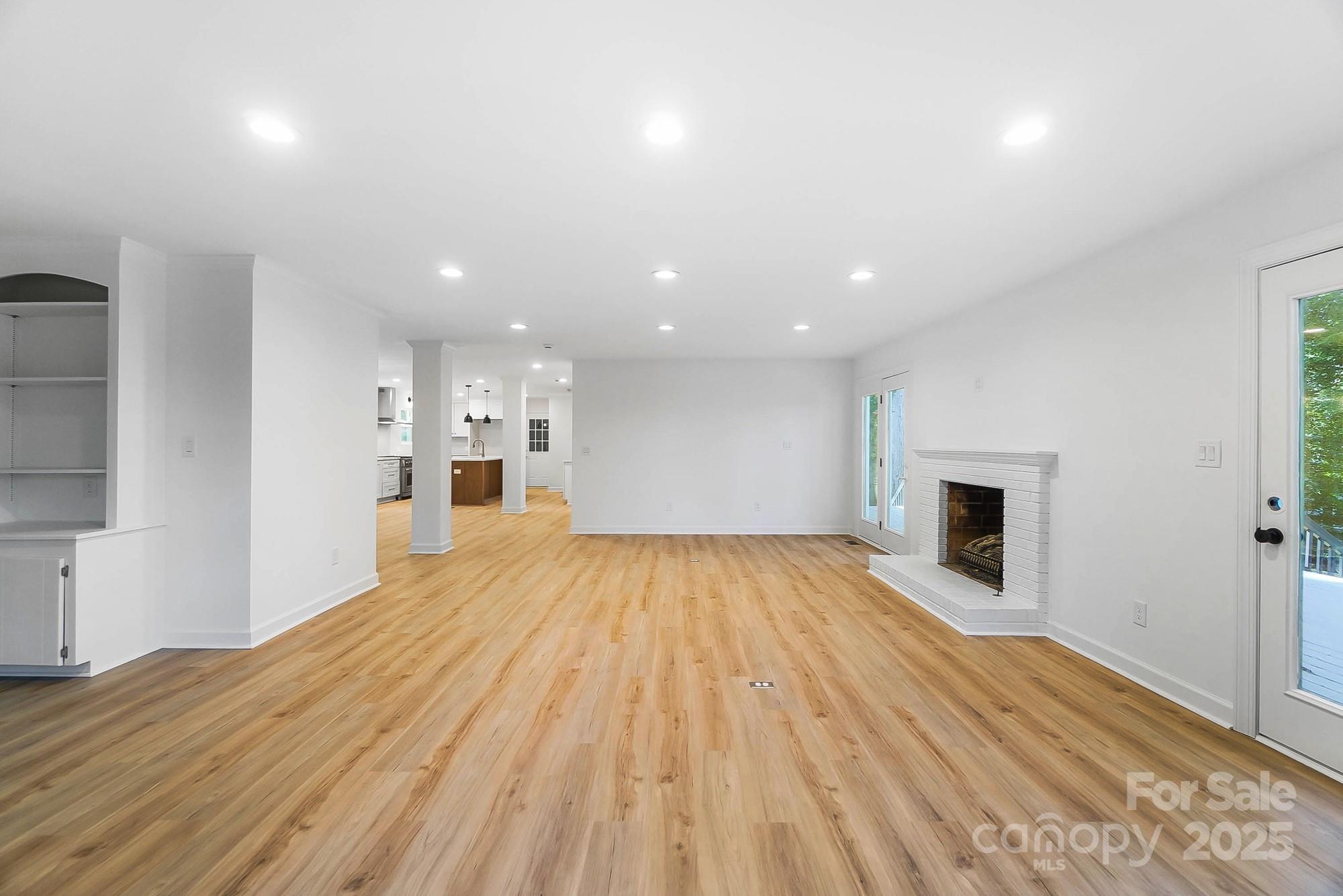 3323 Lincoln Lane Gastonia, NC 28056 - Photo 14 of 47 a view of empty room with wooden floor and fireplace