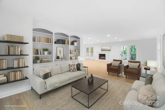 a living room with furniture and a book shelf
