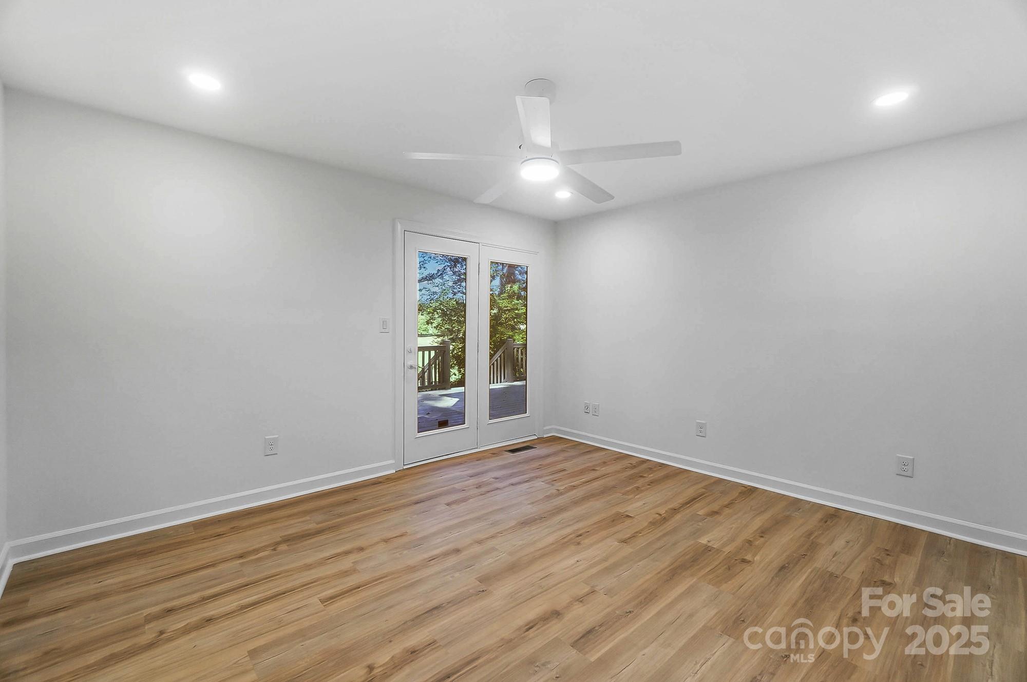 3323 Lincoln Lane Gastonia, NC 28056 - Photo 19 of 47 an empty room with wooden floor and windows