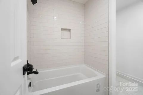 a bath tub sitting next to a white sink