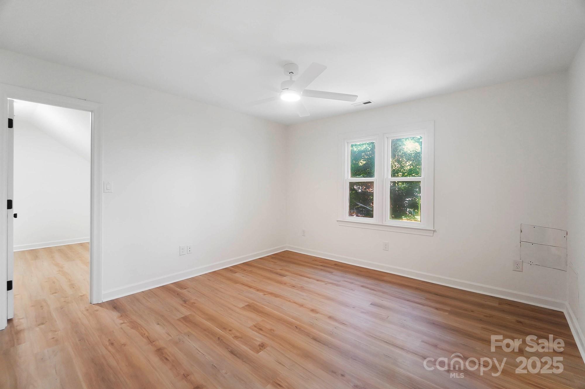3323 Lincoln Lane Gastonia, NC 28056 - Photo 29 of 47 an empty room with wooden floor and windows