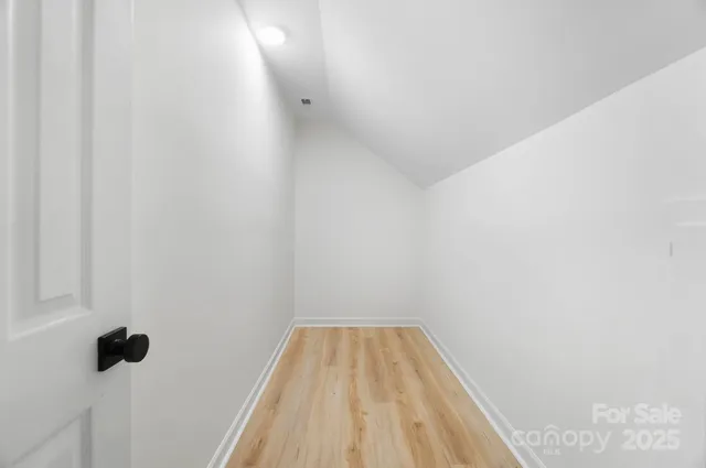 a view of a room with wooden floor