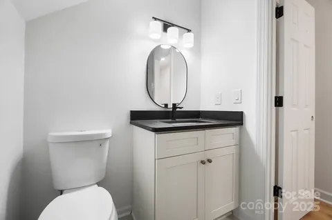 a bathroom with a toilet a sink and a mirror