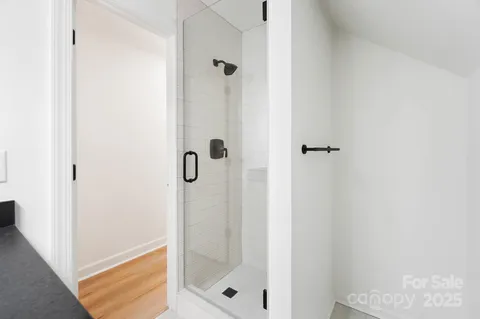 a bathroom with a glass shower door