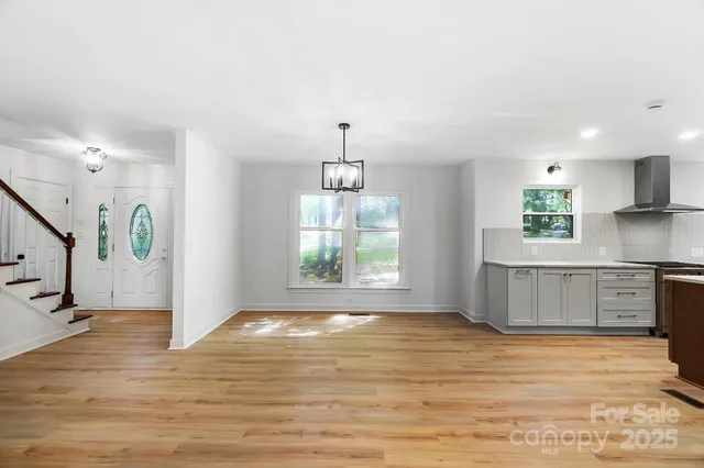 a view of a kitchen with a sink cabinets and wooden floor